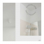 White porcelain wall light with glass globe for bathroom or outdoor use.