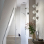 White porcelain wall light with glass globe for bathroom or outdoor use.