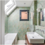 White porcelain wall light with glass globe for bathroom or outdoor use.