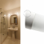 White porcelain wall light with glass globe for bathroom or outdoor use.