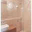 White porcelain wall light with glass globe for bathroom or outdoor use.