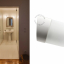 White porcelain wall light with glass globe for bathroom or outdoor use.
