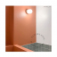 White porcelain wall light with glass globe for bathroom or outdoor use.