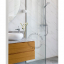 White porcelain wall light with glass globe for bathroom or outdoor use.
