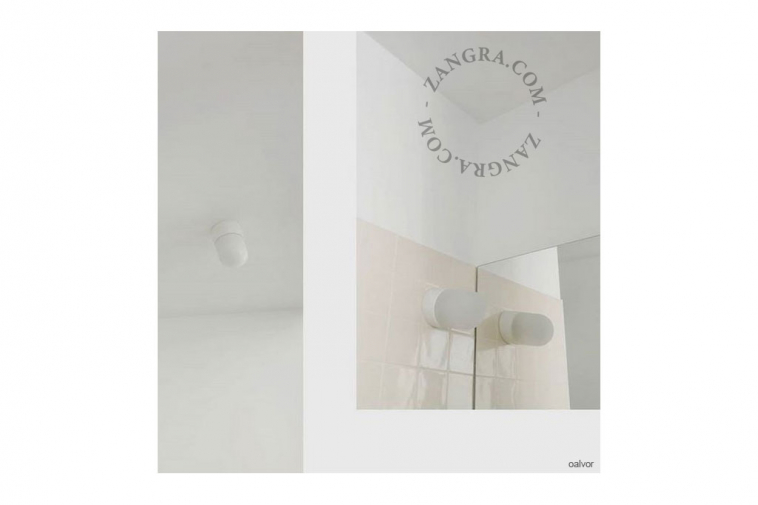 White porcelain wall light with glass globe for bathroom or outdoor use.