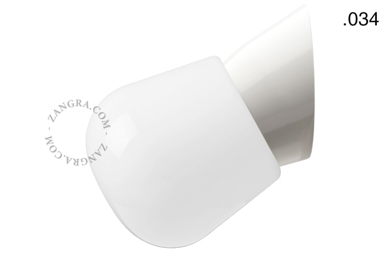 White wall light fixture with glass shade.