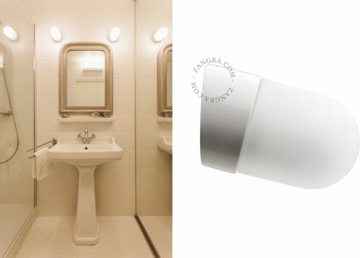 White porcelain wall light with glass globe for bathroom or outdoor use.