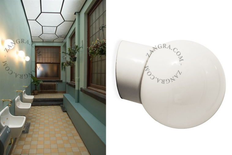 White porcelain wall light with glass globe for bathroom or outdoor use.