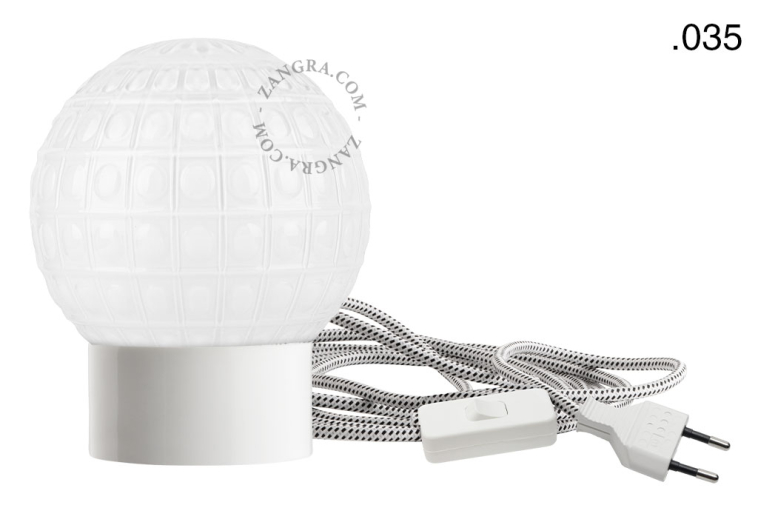 White porcelain table lamp with glass shade.