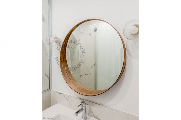 White porcelain wall light with glass globe for bathroom or outdoor use.