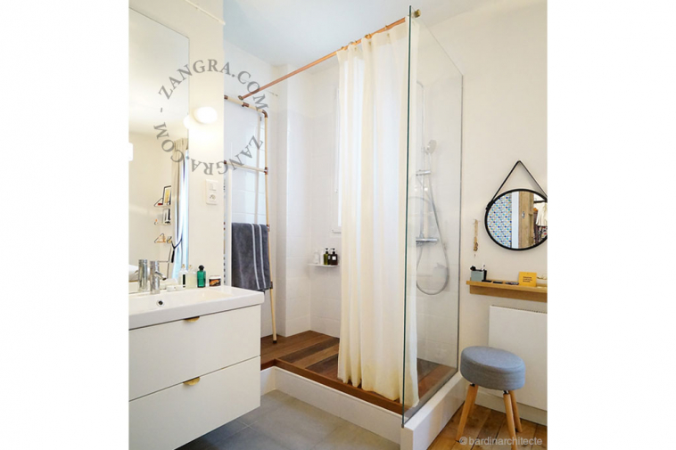 White porcelain wall light with glass globe for bathroom or outdoor use.