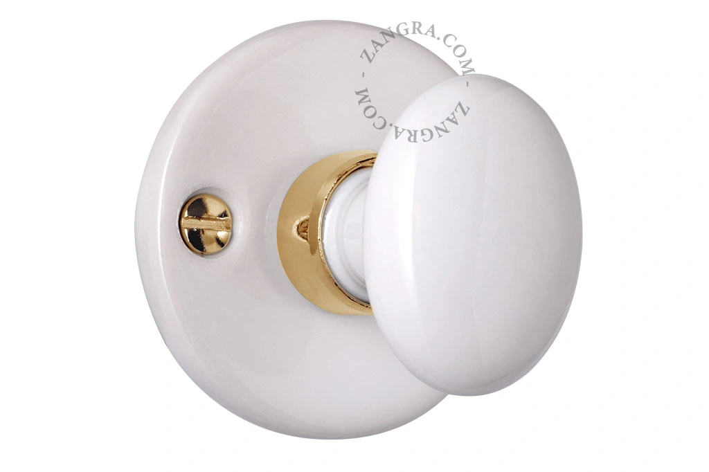 white porcelain and brass rosette and thumb turn lock