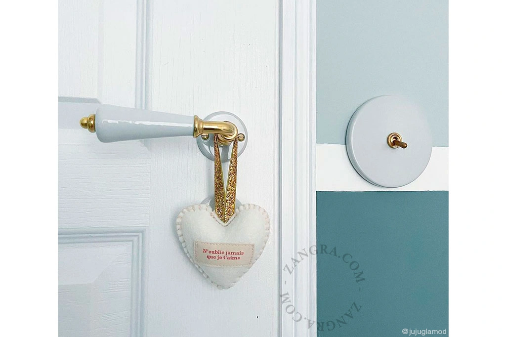 white porcelain and brass double door handle