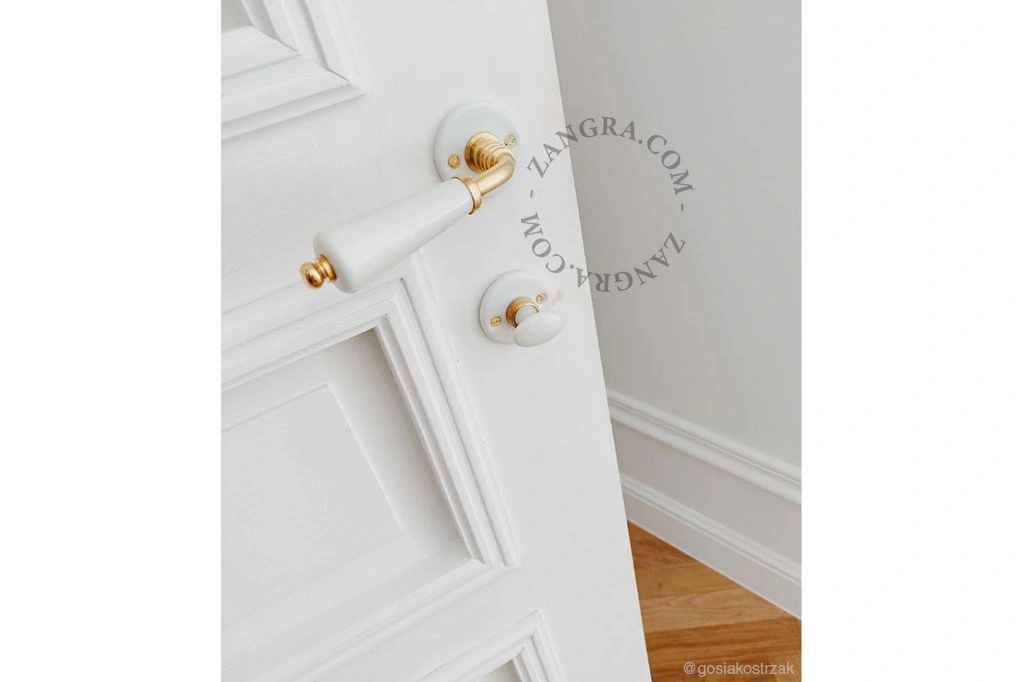 white porcelain and brass double door handle