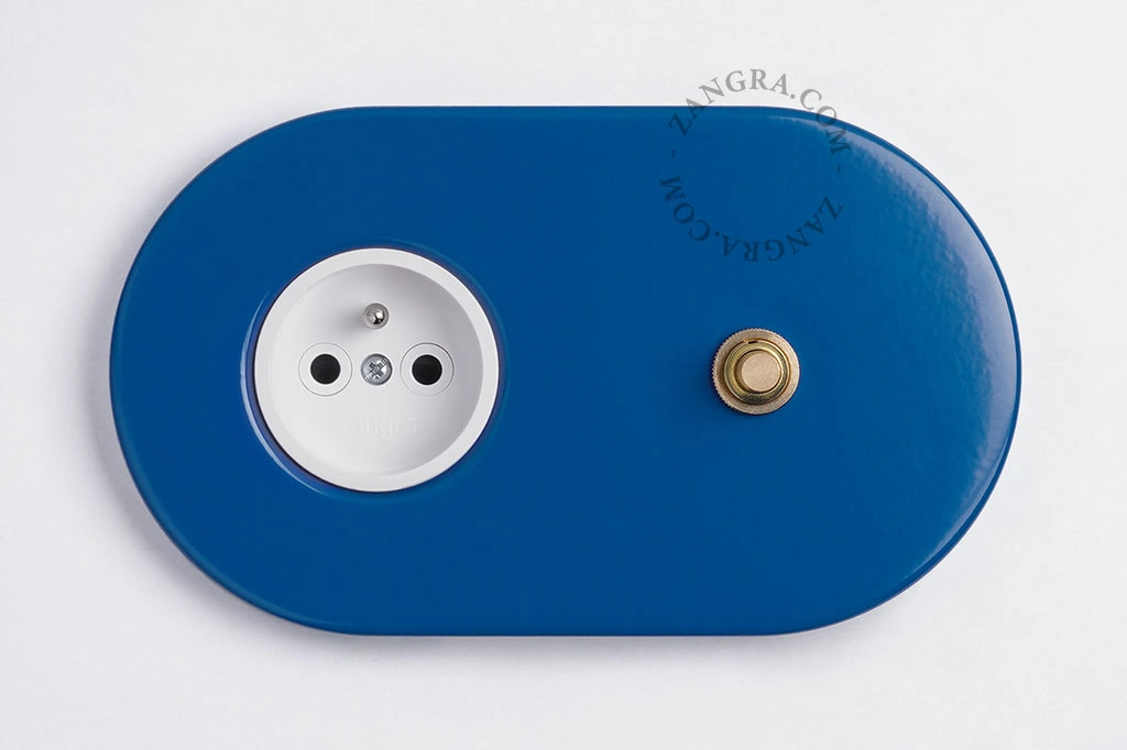 blauw stopcontact met goudkleurige drukknop