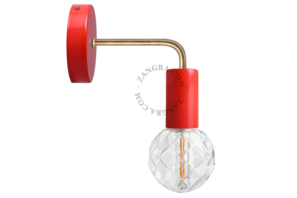 red wall light with brass arm