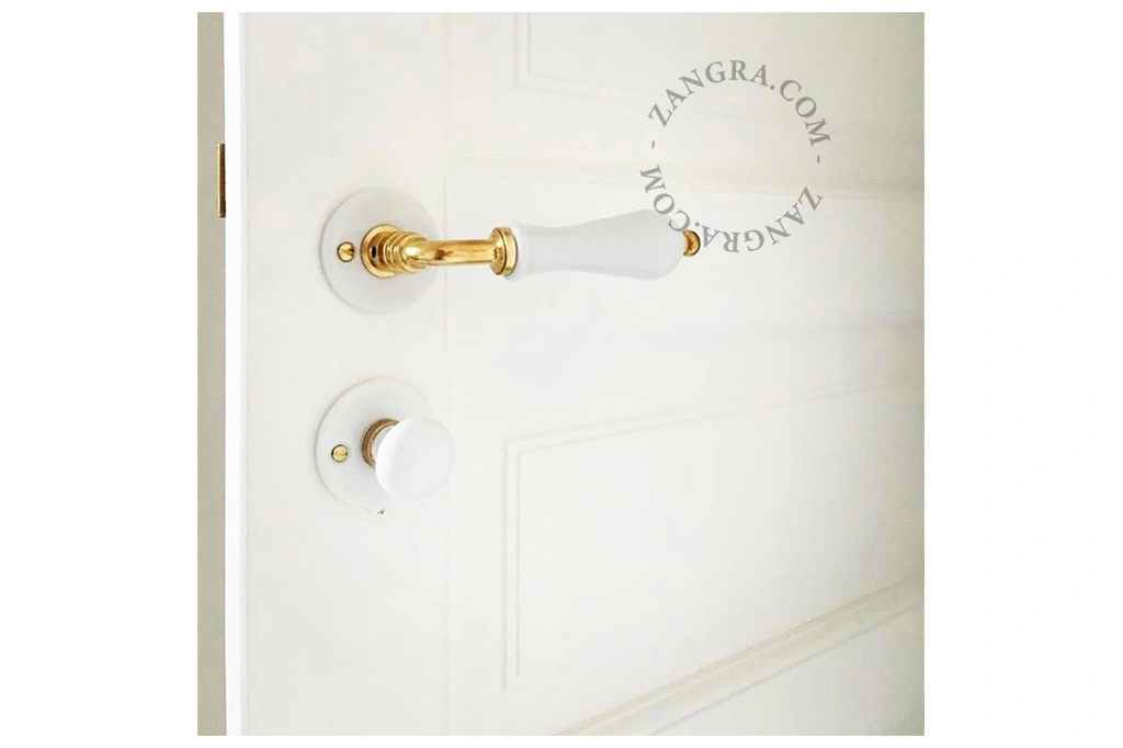 white porcelain and brass rosette and thumb turn lock