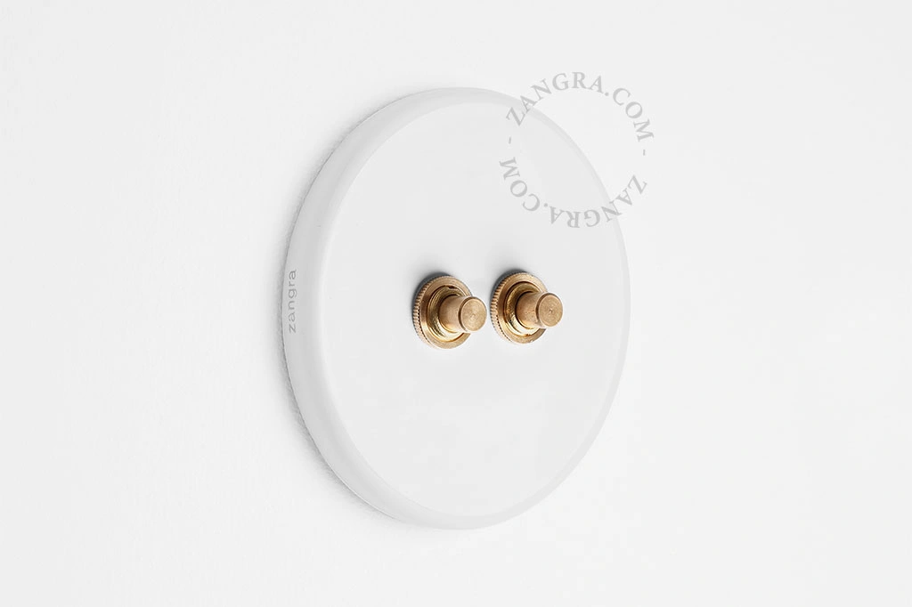 double interrupteur en porcelaine blanche - boutons-poussoirs en laiton