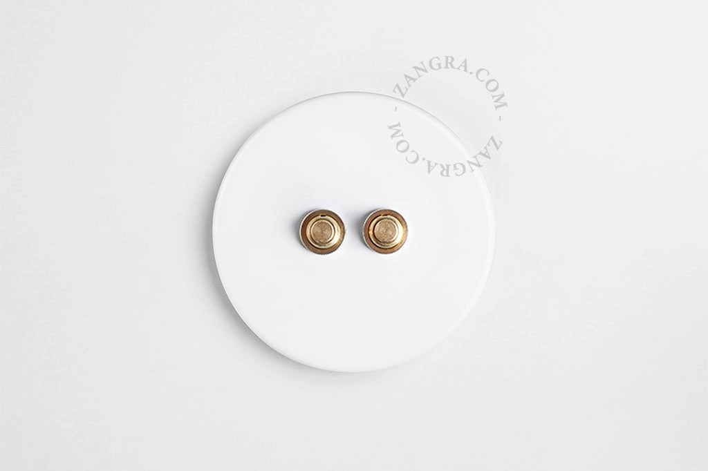 double interrupteur en porcelaine blanche - boutons-poussoirs en laiton