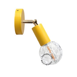 yellow adjustable wall light with brass arm