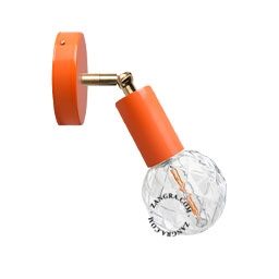 orange adjustable wall light with brass arm
