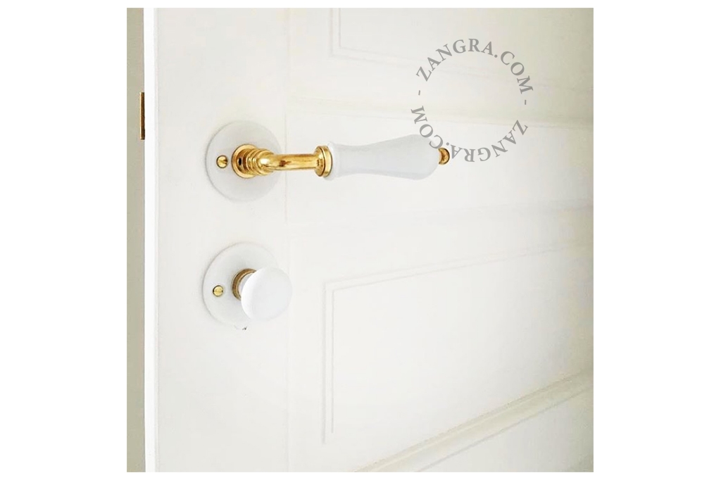 white porcelain and brass rosette and thumb turn lock