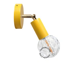 yellow adjustable wall light with brass arm