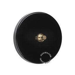 black push switch with gold colored raw brass push button