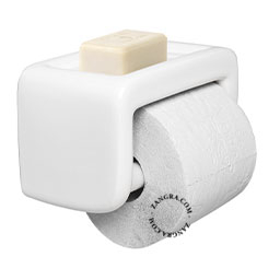 White porcelain toilet paper dispenser with soap holder.