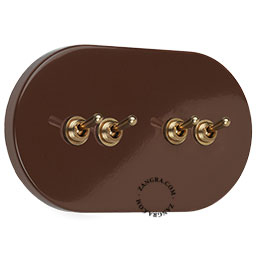 Large brown 4-lever brass light switch.