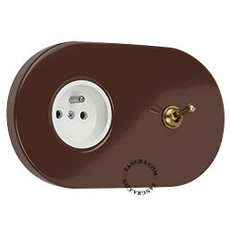 Brown flush mount outlet + switch with raw brass toggle.