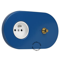 Blue flush mount outlet & switch with raw brass pushbutton.