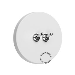 White round light switch with 2 nickel toggles