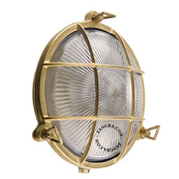 Raw brass ship light for bathroom or outdoor use.