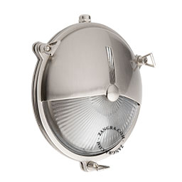 Silvery ship light for bathroom or outdoor use.
