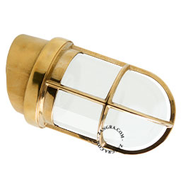 Marine-inspired brass wall light with opal glass.