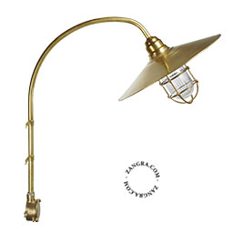 Brass wall light with curved arm.