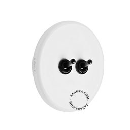 Round white porcelain light switch.