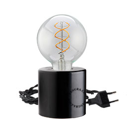 Black porcelain table lamp with exposed light bulb.