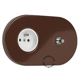 Brown flush mount outlet with pushbutton.