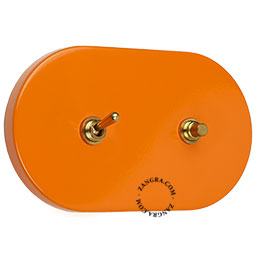 grand interrupteur orange combinant bouton-poussoir et interrupteur à bascule en laiton brut