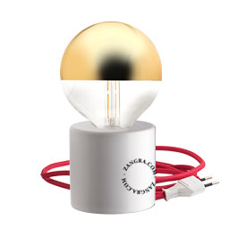 White porcelain table lamp with golden exposed light bulb and red cable.