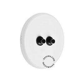 Round white porcelain light switch.