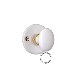 Thumb turn and release in white porcelain and brass.