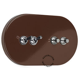 Large brown light switch with 2 levers and 2 pushbuttons.