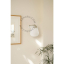 White porcelain wall light with glass globe for bathroom or outdoor use.