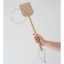 Leather fly swatter with a wooden handle.