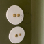 Round white porcelain light switch.