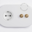 2 brass push buttons and white outlet.