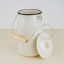 Ivory enamel compost bin with wooden handle.